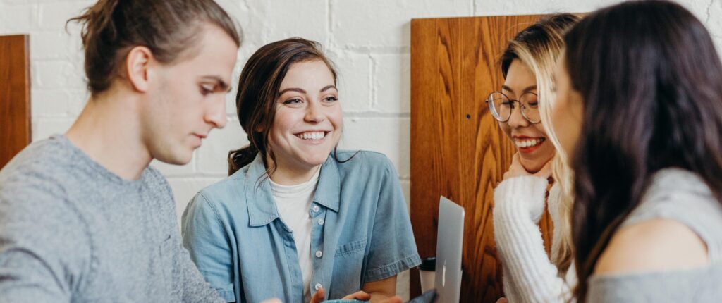 Personas compartiendo ideas frente a un portátil